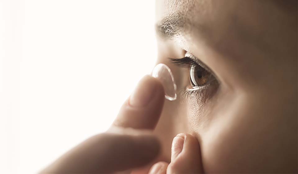 Lady putting contact lenses on