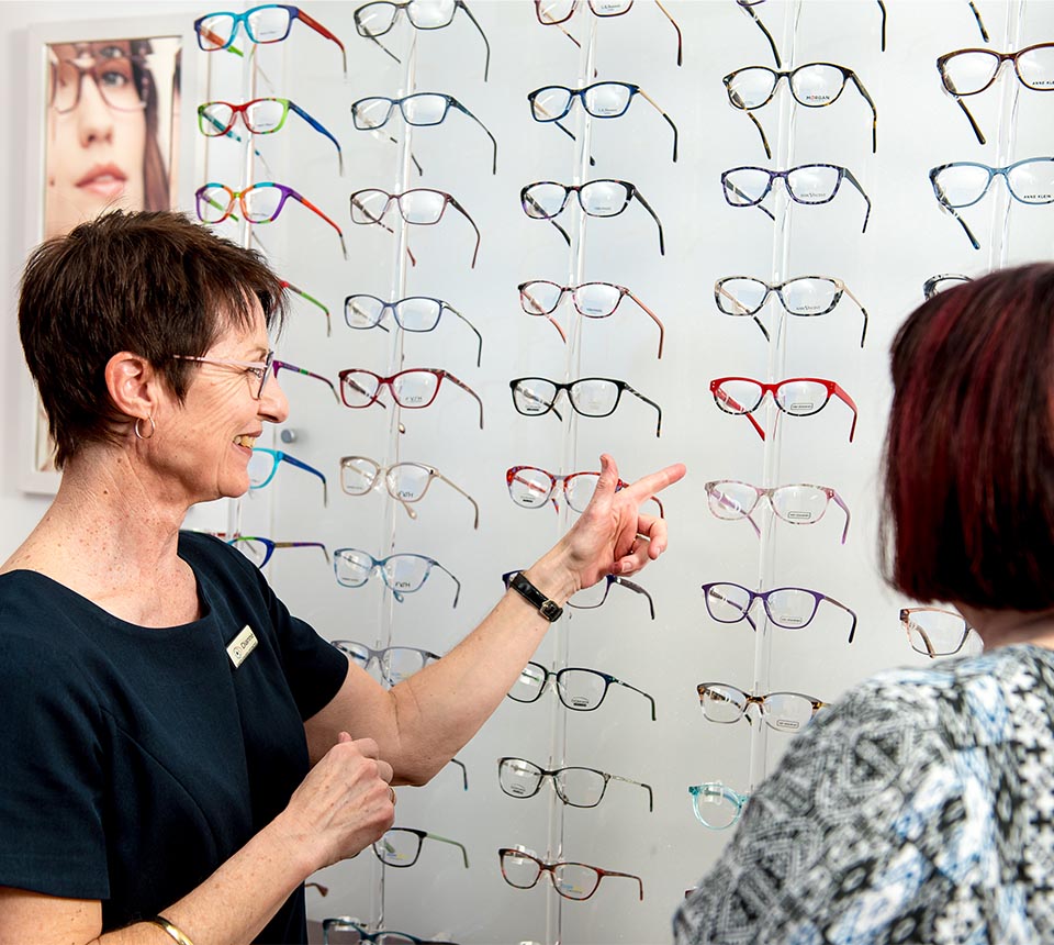 Gareth Edwards Optometrist team member helping customer select frames